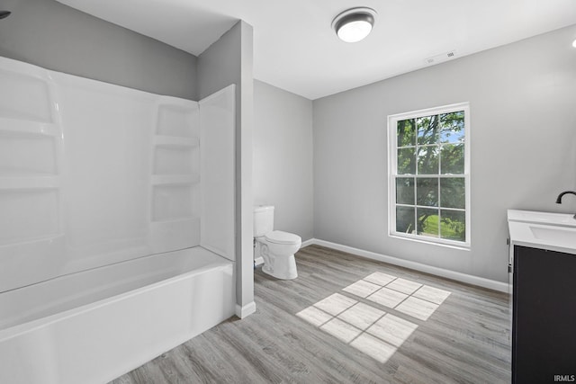 809 E 5th St, Fowler, IN 47944 - bathroom featuring wood finished floors, vanity, and washtub / shower combination