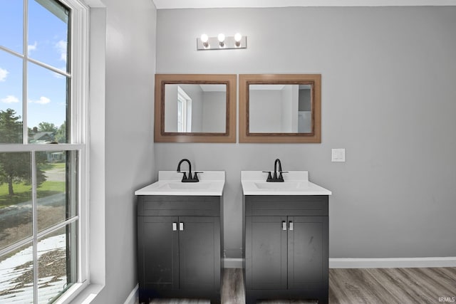 809 E 5th St, Fowler, IN 47944 - bathroom with two vanities and wood finished floors