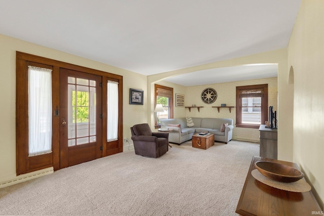 220 N Line St, Churubusco, IN 46723 - carpeted living area featuring arched walkways and a baseboard heating unit