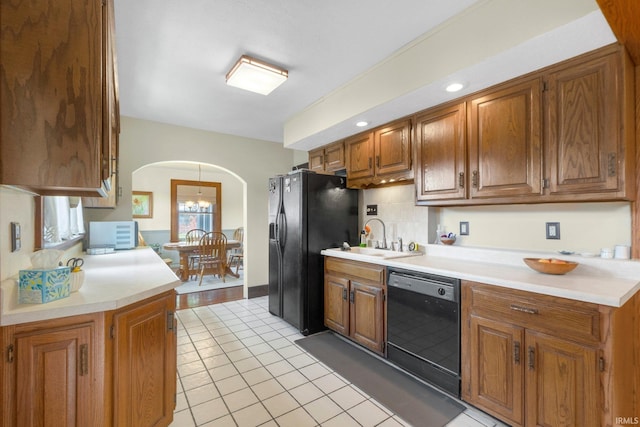 220 N Line St, Churubusco, IN 46723 - kitchen with black appliances, arched walkways, and brown cabinets