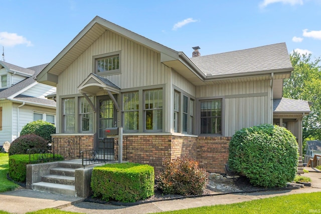 220 N Line St, Churubusco, IN 46723 - view of front of house with brick siding, a chimney, and a shingled roof