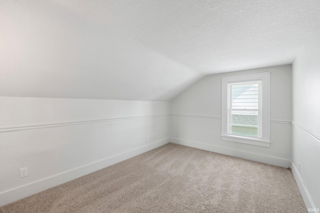 220 N Line St, Churubusco, IN 46723 - bonus room featuring vaulted ceiling, light carpet, and a textured ceiling