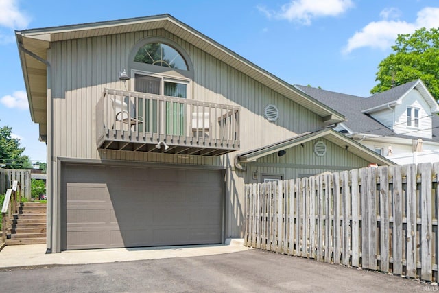 220 N Line St, Churubusco, IN 46723 - townhome / multi-family property featuring a balcony, an attached garage, and driveway