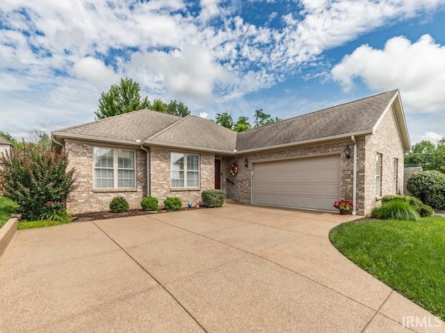 805 Alyssum Dr, Evansville, IN 47712 - ranch-style home featuring brick siding, concrete driveway, a garage, and roof with shingles