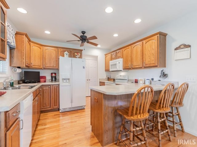 805 Alyssum Dr, Evansville, IN 47712 - kitchen with white appliances, a peninsula, ceiling fan, light wood-type flooring, and recessed lighting