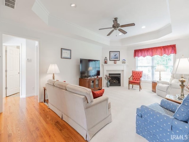 805 Alyssum Dr, Evansville, IN 47712 - living room featuring a tray ceiling, a ceiling fan, a fireplace, recessed lighting, and crown molding