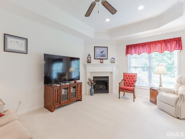805 Alyssum Dr, Evansville, IN 47712 - living room with a tray ceiling, crown molding, a fireplace, light carpet, and ceiling fan