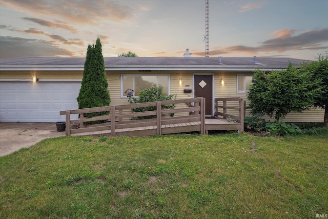 5210 W Washington St, South Bend, IN 46619 - single story home with a wooden deck, a lawn, concrete driveway, and an attached garage
