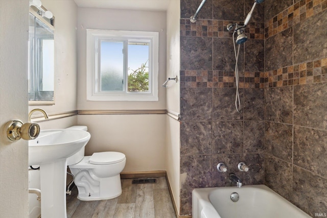 5210 W Washington St, South Bend, IN 46619 - full bathroom featuring wood finished floors and bathing tub / shower combination