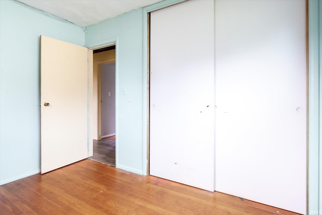 5210 W Washington St, South Bend, IN 46619 - unfurnished bedroom featuring a closet and light wood-style floors
