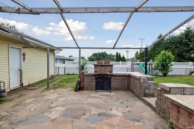 5210 W Washington St, South Bend, IN 46619 - fenced backyard with an outdoor fireplace and a patio