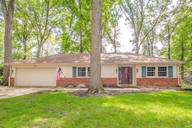 2613 Queensbury Rd, Muncie, IN 47304 - single story home featuring brick siding, a garage, a front yard, and concrete driveway