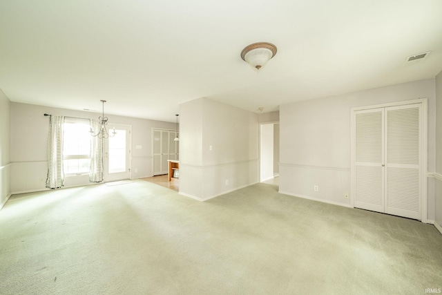 2613 Queensbury Rd, Muncie, IN 47304 - unfurnished living room with light carpet and a chandelier