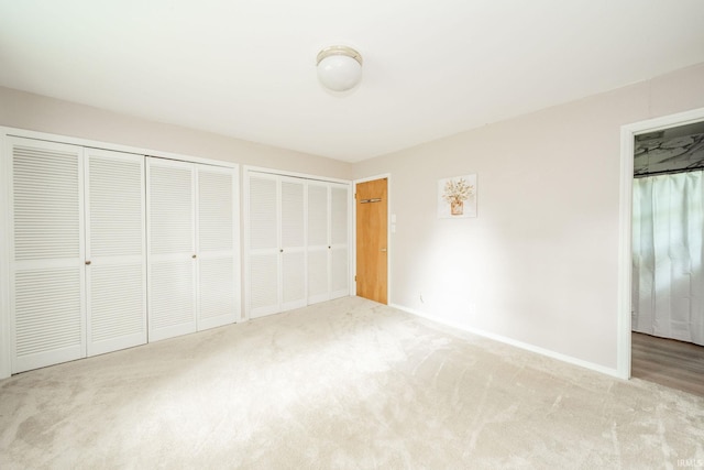 2613 Queensbury Rd, Muncie, IN 47304 - unfurnished bedroom featuring carpet floors and two closets