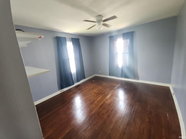 2407 George St, Logansport, IN 46947 - empty room with ceiling fan, plenty of natural light, and hardwood / wood-style flooring
