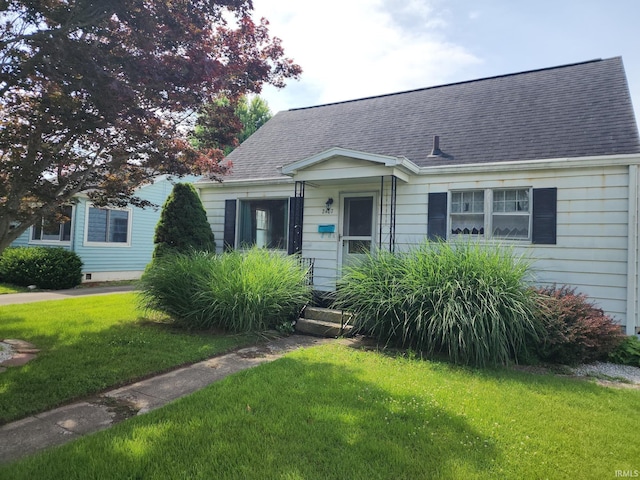 2407 George St, Logansport, IN 46947 - bungalow-style home with a front yard and roof with shingles