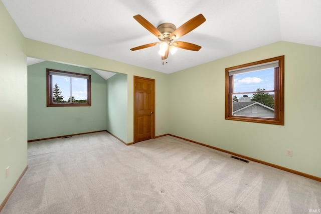 9106 Yellow Tree Ct, Fort Wayne, IN 46804 - unfurnished bedroom featuring multiple windows, light colored carpet, vaulted ceiling, and a ceiling fan