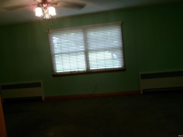 908 N Hawthorne St, Marion, IN 46952 - spare room featuring radiator heating unit, ceiling fan, and plenty of natural light