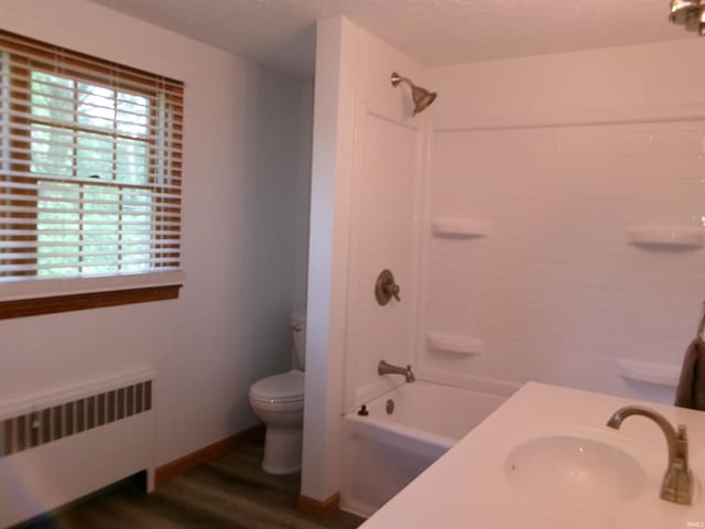908 N Hawthorne St, Marion, IN 46952 - full bathroom with radiator heating unit, bathtub / shower combination, wood finished floors, and vanity