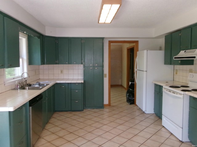 908 N Hawthorne St, Marion, IN 46952 - kitchen with white appliances, green cabinets, under cabinet range hood, tile countertops, and decorative backsplash