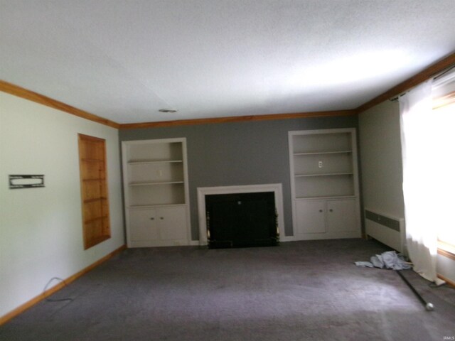 908 N Hawthorne St, Marion, IN 46952 - unfurnished living room with built in shelves, radiator, ornamental molding, carpet, and healthy amount of natural light