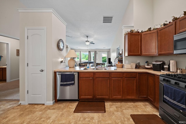 807 Percheron Pl, Lafayette, IN 47905 - kitchen with appliances with stainless steel finishes, brown cabinets, ceiling fan, and light countertops