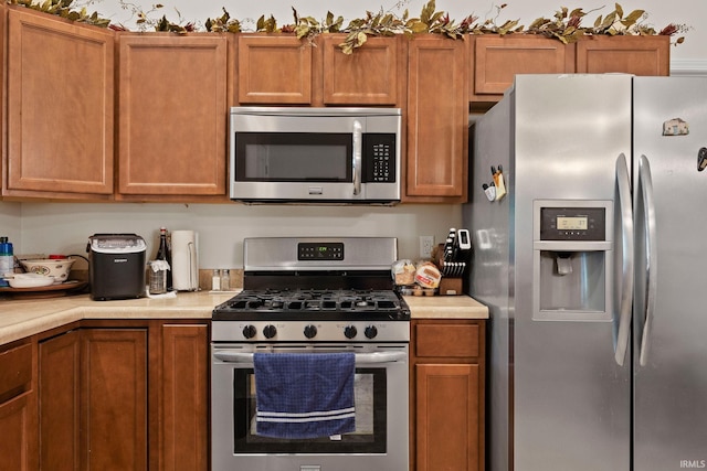 807 Percheron Pl, Lafayette, IN 47905 - kitchen featuring stainless steel appliances, light countertops, and brown cabinets