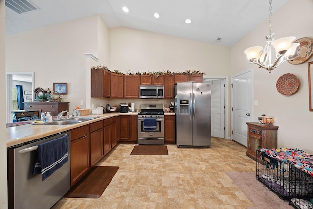 807 Percheron Pl, Lafayette, IN 47905 - kitchen with stainless steel appliances, high vaulted ceiling, a chandelier, light countertops, and brown cabinets