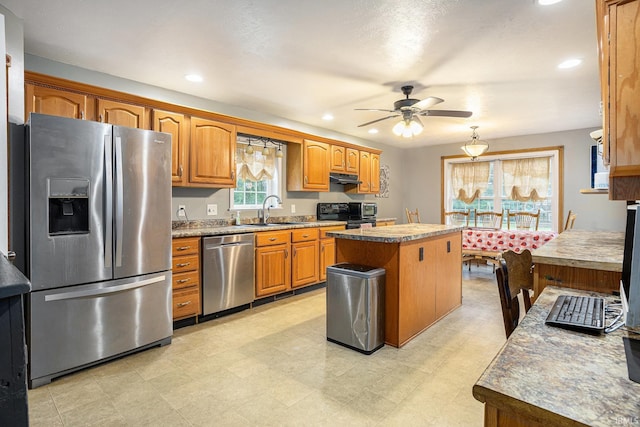 58380 Ash Rd, Osceola, IN 46561 - kitchen featuring stainless steel appliances, a center island, ceiling fan, brown cabinets, and recessed lighting