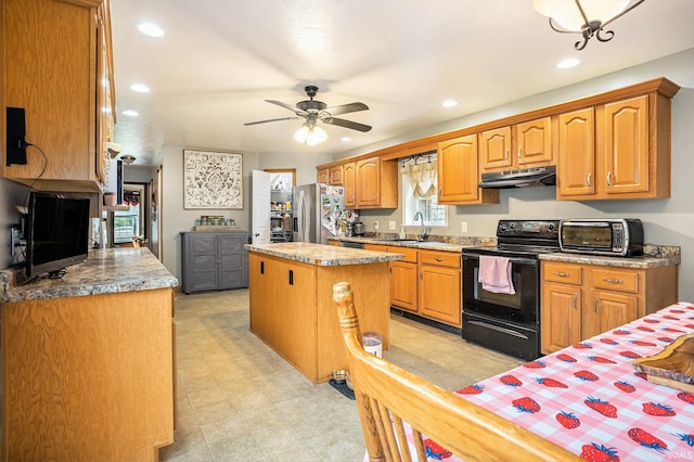58380 Ash Rd, Osceola, IN 46561 - kitchen featuring under cabinet range hood, black electric range, stainless steel fridge, a center island, and recessed lighting
