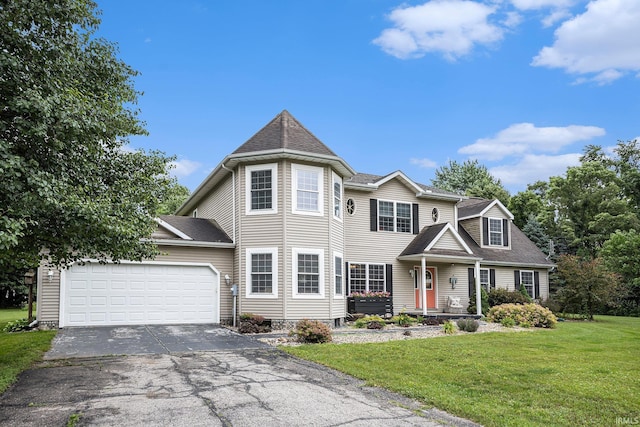 58380 Ash Rd, Osceola, IN 46561 - view of front of home with asphalt driveway, a garage, a front lawn, and roof with shingles