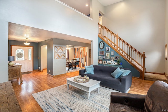 58380 Ash Rd, Osceola, IN 46561 - living room with light wood-type flooring, stairs, and a towering ceiling