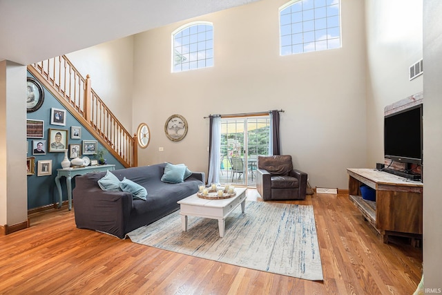 58380 Ash Rd, Osceola, IN 46561 - living room featuring a towering ceiling, wood finished floors, and stairway