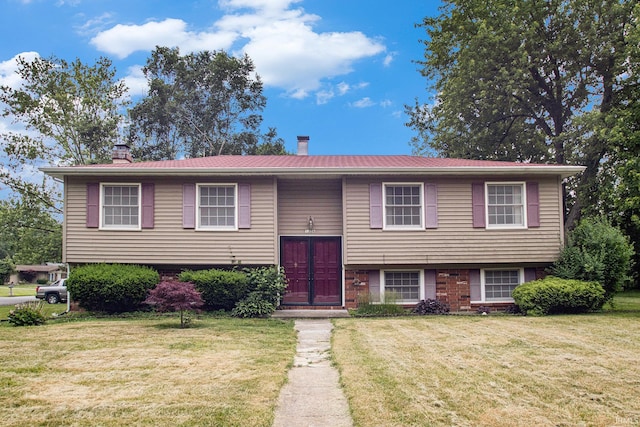 1356 Hampshire Dr, South Bend, IN 46614 - bi-level home with a chimney, a front yard, and brick siding