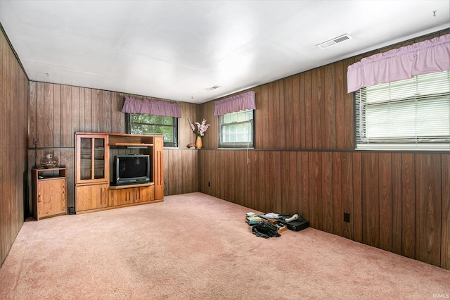 1356 Hampshire Dr, South Bend, IN 46614 - unfurnished living room featuring healthy amount of natural light, carpet, and wood walls