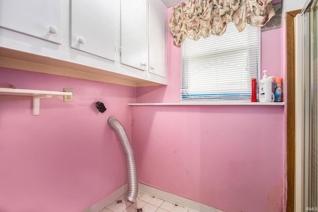 1356 Hampshire Dr, South Bend, IN 46614 - laundry room with cabinet space, light tile patterned flooring, and electric dryer hookup