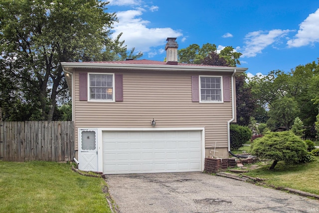 1356 Hampshire Dr, South Bend, IN 46614 - view of front of property with a chimney, driveway, and an attached garage