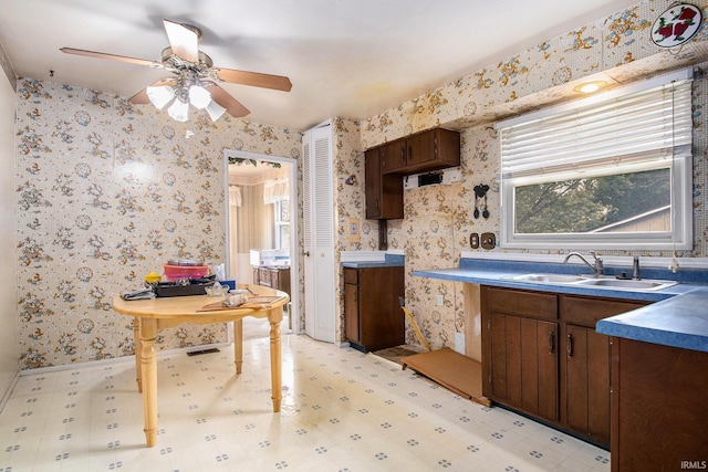 1356 Hampshire Dr, South Bend, IN 46614 - kitchen with wallpapered walls, ceiling fan, and dark brown cabinets