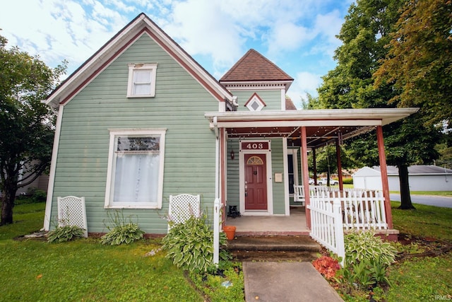 403 E Columbia St, Flora, IN 46929 - victorian-style house with a porch and a front lawn