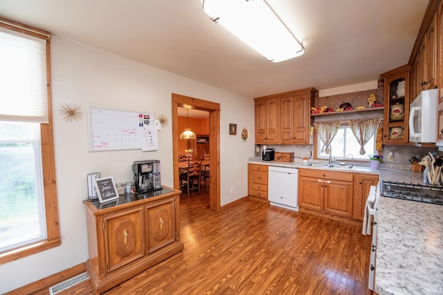 403 E Columbia St, Flora, IN 46929 - kitchen with white appliances, light wood-type flooring, brown cabinetry, and light countertops