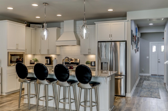 5573 Camden Dr, Newburgh, IN 47630 - kitchen with custom range hood, appliances with stainless steel finishes, white cabinetry, light stone counters, and recessed lighting