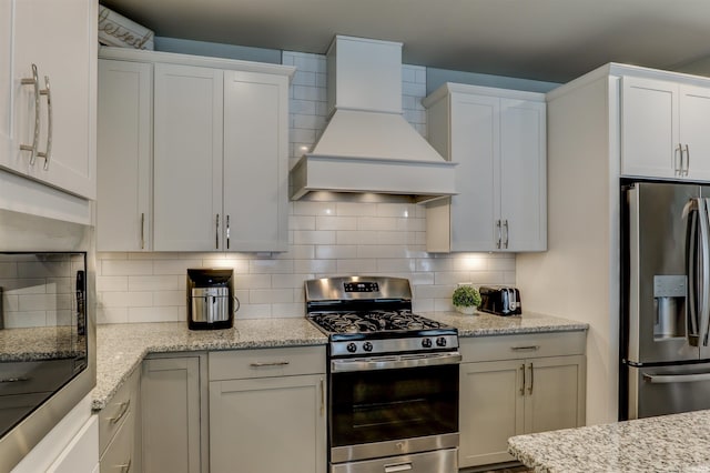 5573 Camden Dr, Newburgh, IN 47630 - kitchen with appliances with stainless steel finishes, custom range hood, tasteful backsplash, and white cabinets