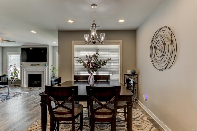 5573 Camden Dr, Newburgh, IN 47630 - dining space with a ceiling fan, wood finished floors, a fireplace, and recessed lighting