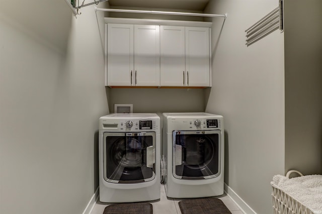 5573 Camden Dr, Newburgh, IN 47630 - laundry area featuring washer and dryer, cabinet space, and tile patterned flooring