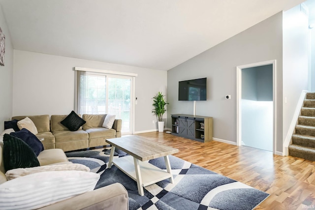 5209 Jenny Ln, Mishawaka, IN 46545 - living room featuring vaulted ceiling, light wood-style flooring, and stairway