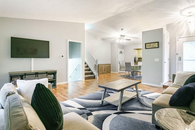 5209 Jenny Ln, Mishawaka, IN 46545 - living area featuring stairway, light wood finished floors, a ceiling fan, and lofted ceiling