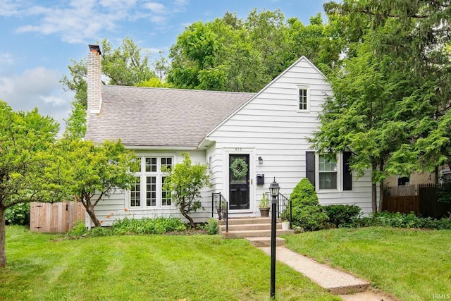 415 Wakewa Ave, South Bend, IN 46617 - view of front of house featuring roof with shingles and a chimney
