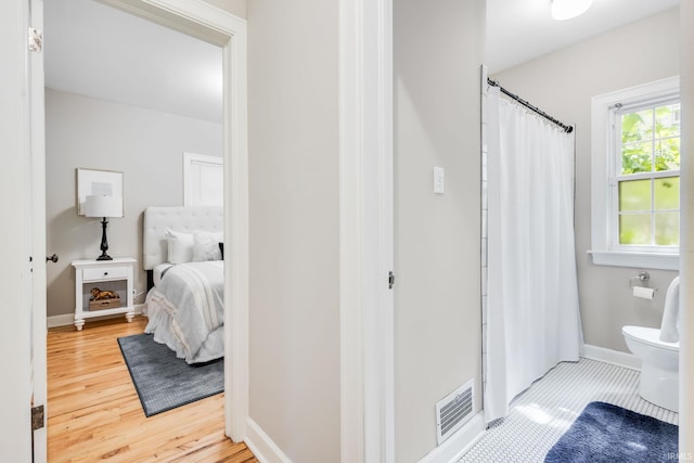 415 Wakewa Ave, South Bend, IN 46617 - bathroom with wood finished floors, curtained shower, and ensuite bathroom