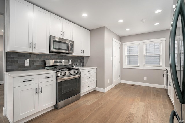 1414 Longfellow Ave, South Bend, IN 46615 - kitchen with stainless steel appliances, light countertops, tasteful backsplash, light wood-type flooring, and recessed lighting