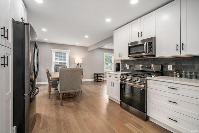 1414 Longfellow Ave, South Bend, IN 46615 - kitchen with stainless steel appliances, light countertops, decorative backsplash, light wood finished floors, and recessed lighting
